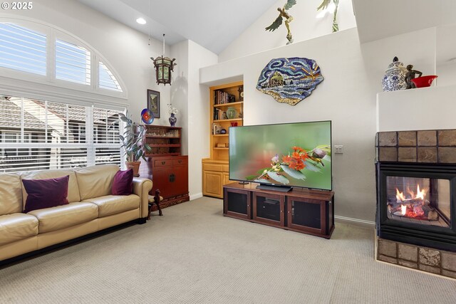 carpeted living room featuring high vaulted ceiling, a healthy amount of sunlight, and built in shelves