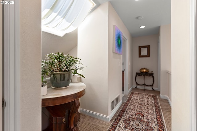 hallway featuring carpet flooring