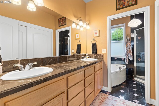 bathroom featuring tile patterned flooring, shower with separate bathtub, and vanity