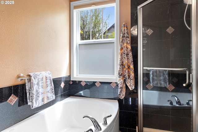 bathroom featuring shower with separate bathtub