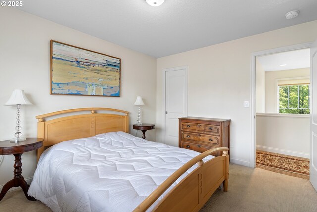 bedroom featuring light colored carpet