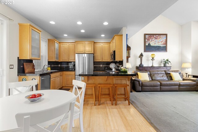 dining room with light hardwood / wood-style flooring and a fireplace