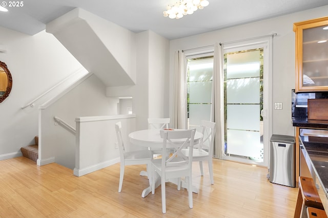 dining space featuring a chandelier and light hardwood / wood-style floors