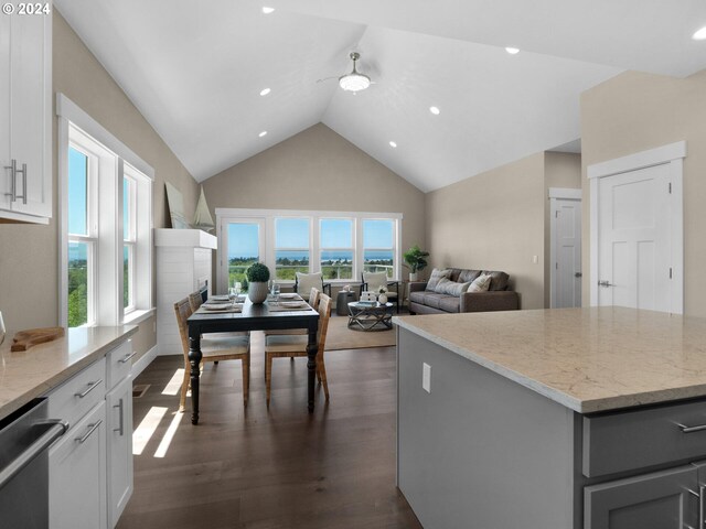 1790 Thompson Falls Dr, Seaside, OR 97138 - kitchen featuring a ceiling fan, high vaulted ceiling, stainless steel dishwasher, light stone counters, and dark wood-style flooring