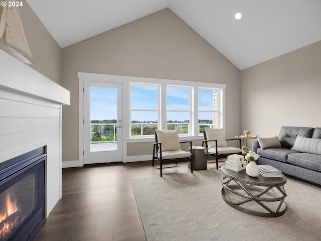 1790 Thompson Falls Dr, Seaside, OR 97138 - living area with a warm lit fireplace, high vaulted ceiling, plenty of natural light, dark wood finished floors, and recessed lighting