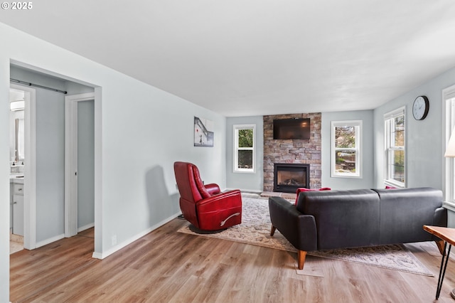 2385 S Downing St, Seaside, OR 97138 - living area featuring light wood-type flooring, a fireplace, and a barn door