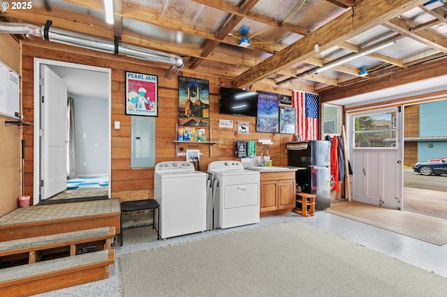 2385 S Downing St, Seaside, OR 97138 - misc room featuring washer and dryer, wooden walls, electric panel, and dark speckled floor