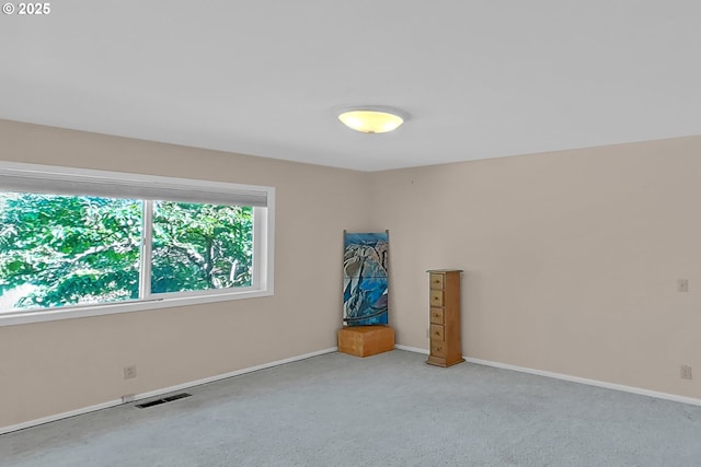 carpeted spare room with baseboards