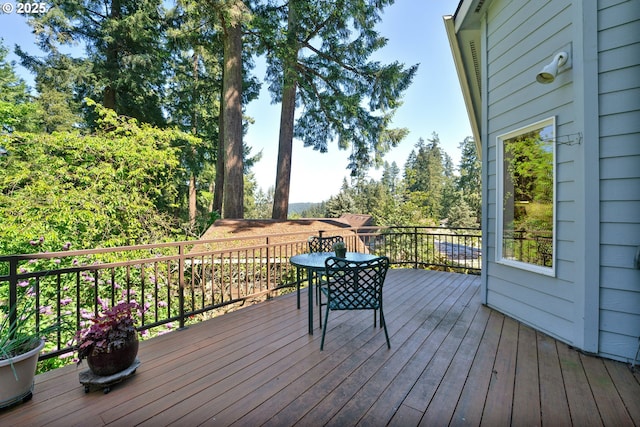 wooden terrace with outdoor dining space