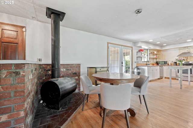 22224 S Kamrath Rd, Oregon City, OR 97045 - dining area featuring a wood stove and light wood-type flooring