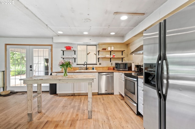 22224 S Kamrath Rd, Oregon City, OR 97045 - kitchen featuring appliances with stainless steel finishes, open shelves, white cabinetry, light wood finished floors, and light countertops