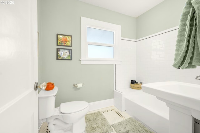 bathroom with toilet, a bathing tub, tile patterned flooring, baseboards, and walk in shower