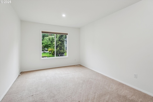 empty room with carpet floors, baseboards, and recessed lighting
