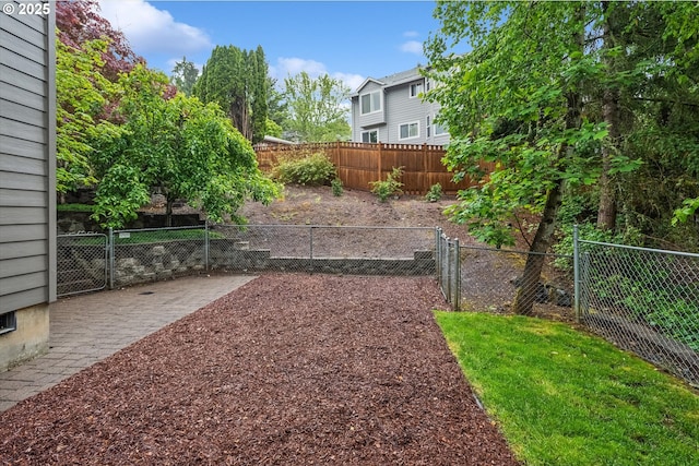 fenced backyard with a patio area