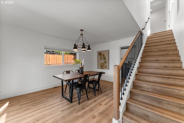 4992 Prospect St, West Linn, OR 97068 - dining space with stairway, light wood-style flooring, and a chandelier