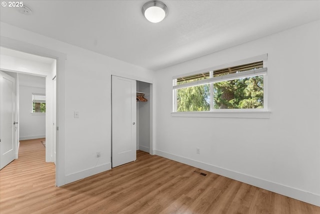 4992 Prospect St, West Linn, OR 97068 - unfurnished bedroom featuring light wood finished floors, multiple windows, and a closet