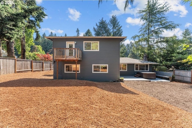 4992 Prospect St, West Linn, OR 97068 - rear view of house with a hot tub, a patio, a fenced backyard, and a balcony