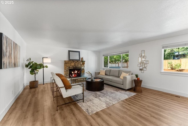 4992 Prospect St, West Linn, OR 97068 - living area featuring wood finished floors and a stone fireplace