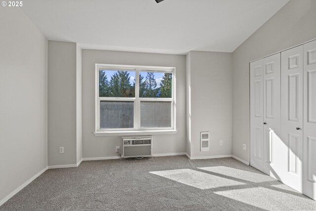 unfurnished bedroom with visible vents, carpet flooring, multiple closets, and lofted ceiling