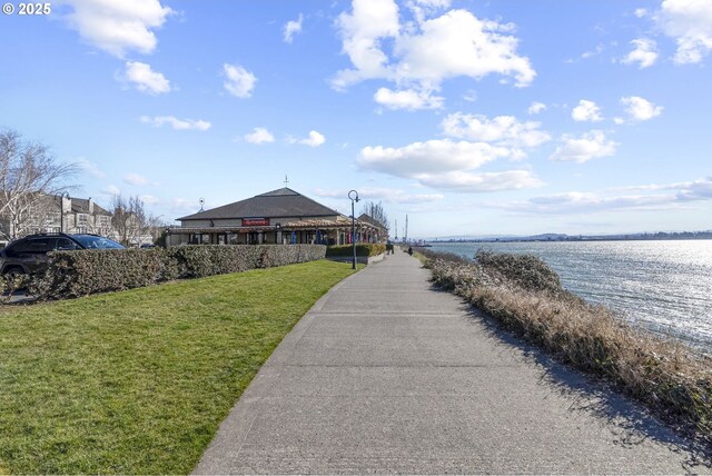 exterior space with a water view and a yard
