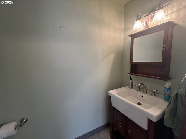 bathroom with double vanity, tile walls, ornamental molding, a freestanding tub, and a sink