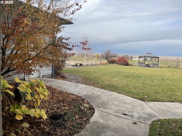 view of yard with a gazebo, fence, and a garage