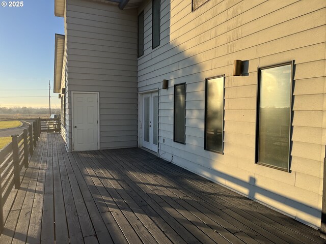 wooden deck with a rural view