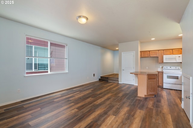 8465 S Hollyhock St, Rockaway Beach, OR 97136 - kitchen with white appliances, dark wood-style floors, recessed lighting, open floor plan, and a center island