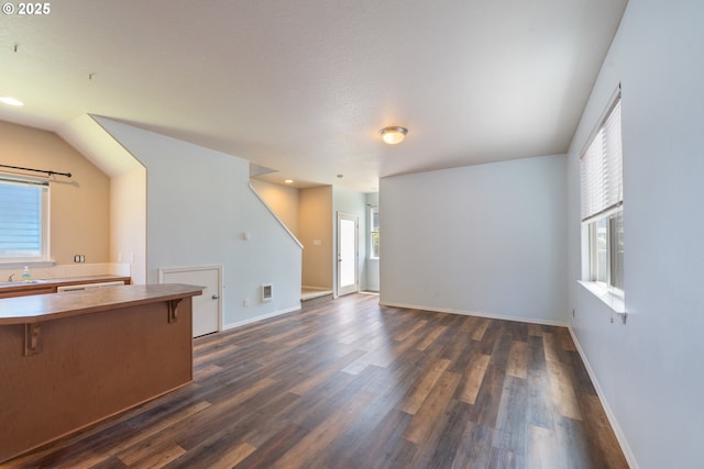 8465 S Hollyhock St, Rockaway Beach, OR 97136 - unfurnished living room featuring dark wood-style floors and recessed lighting