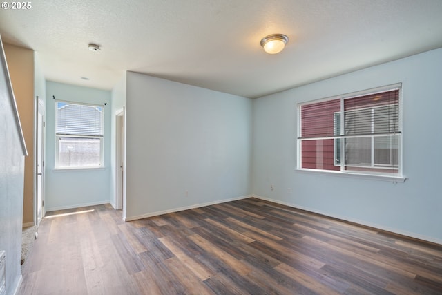 8465 S Hollyhock St, Rockaway Beach, OR 97136 - spare room featuring wood finished floors and baseboards