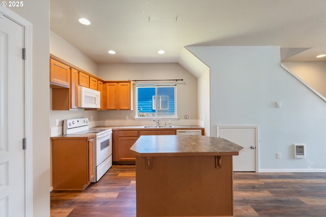 8465 S Hollyhock St, Rockaway Beach, OR 97136 - kitchen featuring white appliances, dark wood-style flooring, a kitchen island, recessed lighting, and vaulted ceiling