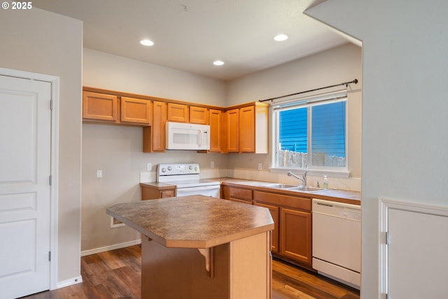 8465 S Hollyhock St, Rockaway Beach, OR 97136 - kitchen featuring white appliances, a kitchen island, dark wood finished floors, recessed lighting, and light countertops