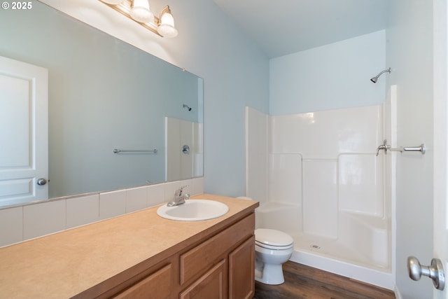 8465 S Hollyhock St, Rockaway Beach, OR 97136 - full bathroom with vanity, a shower, and wood finished floors