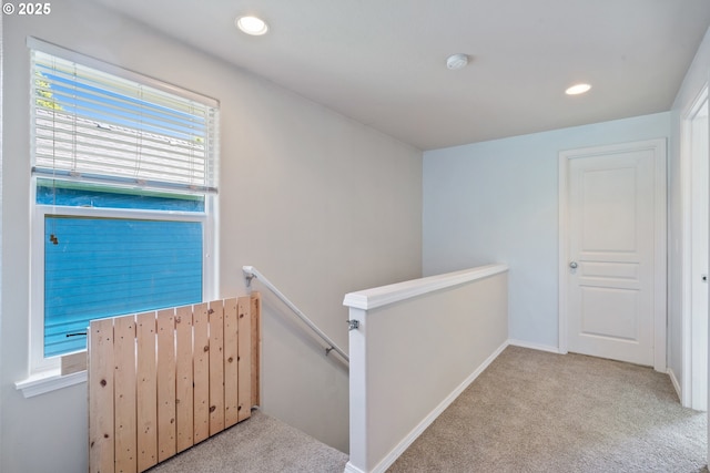 8465 S Hollyhock St, Rockaway Beach, OR 97136 - hallway featuring an upstairs landing, carpet flooring, and recessed lighting