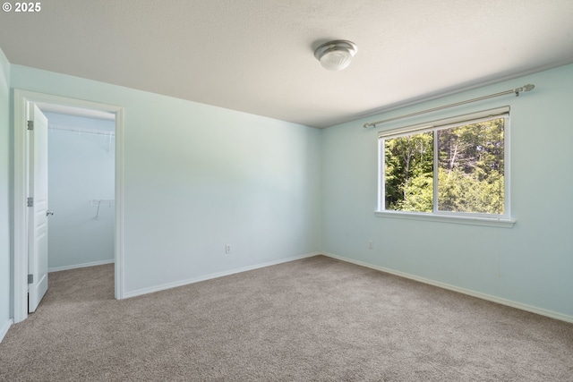 8465 S Hollyhock St, Rockaway Beach, OR 97136 - empty room featuring carpet flooring and baseboards