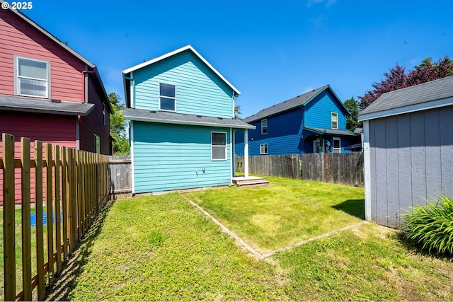 8465 S Hollyhock St, Rockaway Beach, OR 97136 - back of house featuring a fenced backyard and a storage shed