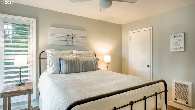 bedroom with a ceiling fan and heating unit