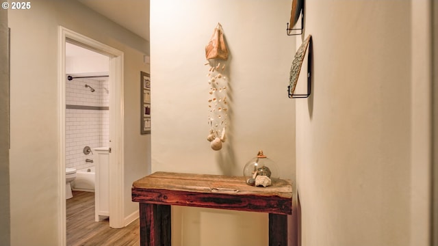 hallway with light wood-style flooring and baseboards