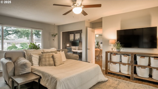 bedroom featuring ceiling fan and wood finished floors