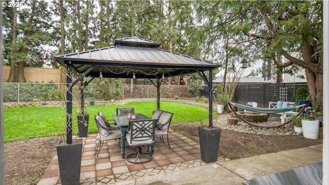 view of patio / terrace featuring a gazebo, a fenced backyard, and outdoor dining space