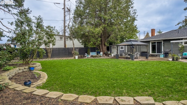 view of yard with a gazebo, a patio area, and a fenced backyard