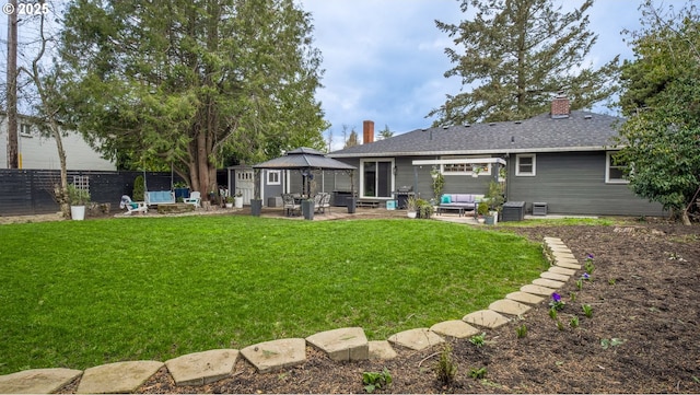 back of property featuring a yard, a gazebo, a patio area, fence, and an outdoor living space