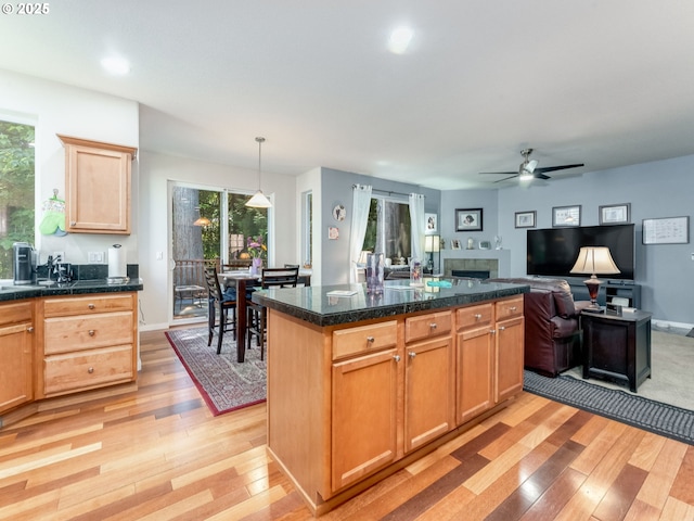 21390 SW Roellich Ave, Sherwood, OR 97140 - kitchen featuring light wood finished floors, a ceiling fan, healthy amount of natural light, a fireplace, and recessed lighting