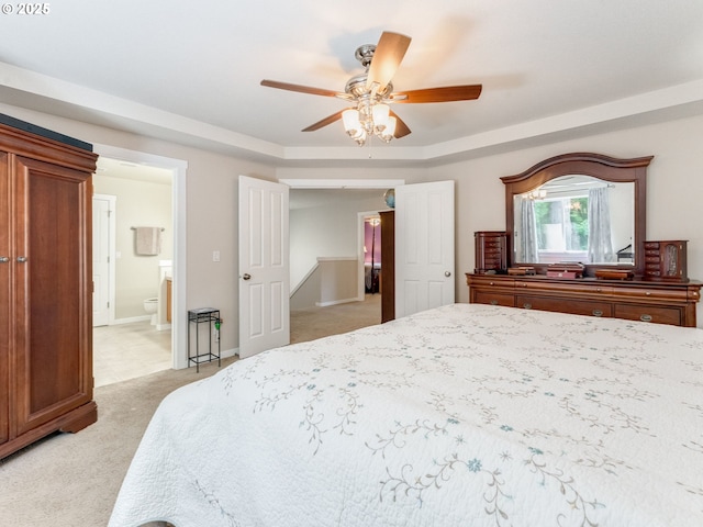 21390 SW Roellich Ave, Sherwood, OR 97140 - bedroom with light carpet, connected bathroom, a raised ceiling, a ceiling fan, and baseboards