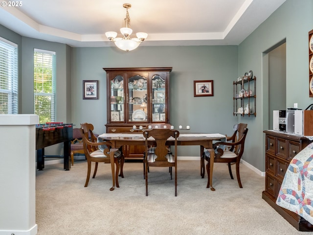 21390 SW Roellich Ave, Sherwood, OR 97140 - dining space featuring a chandelier, a raised ceiling, and light colored carpet