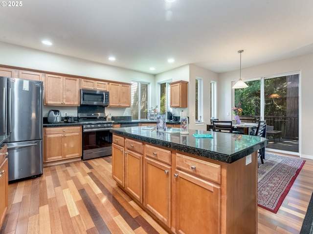 21390 SW Roellich Ave, Sherwood, OR 97140 - kitchen featuring stainless steel appliances, light wood-style flooring, tile counters, plenty of natural light, and recessed lighting