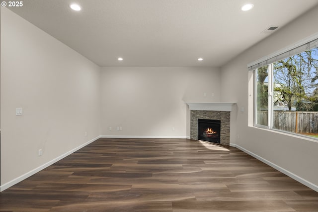 unfurnished living room featuring visible vents, recessed lighting, baseboards, and wood finished floors