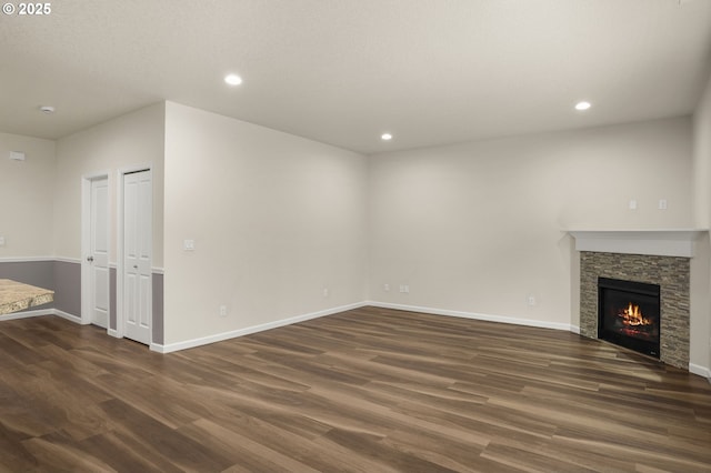 unfurnished living room featuring dark wood finished floors, recessed lighting, and baseboards