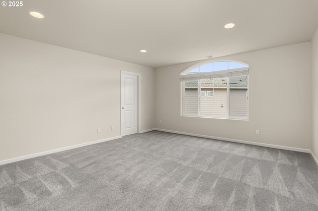 empty room with carpet flooring, recessed lighting, and baseboards