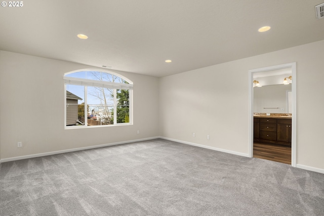 unfurnished bedroom with visible vents, ensuite bathroom, recessed lighting, carpet, and baseboards